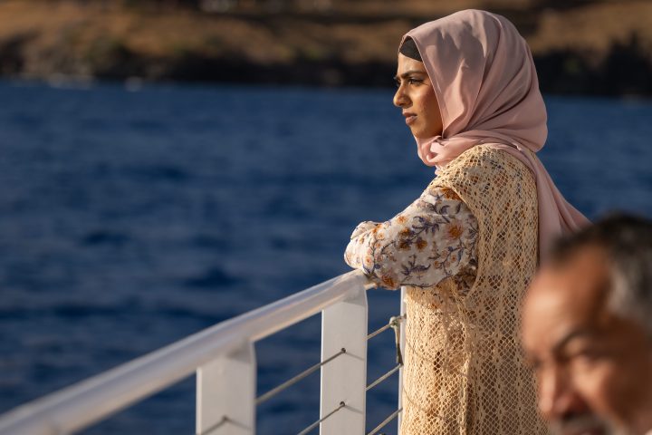 a man standing in front of water
