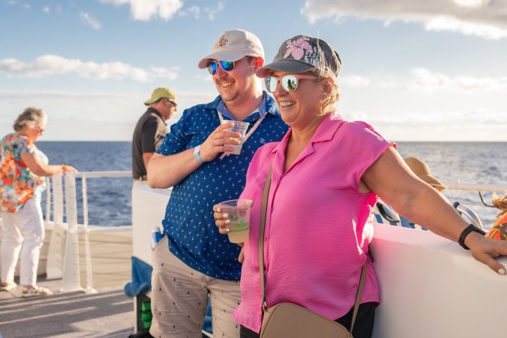 a couple of people that are standing in the water