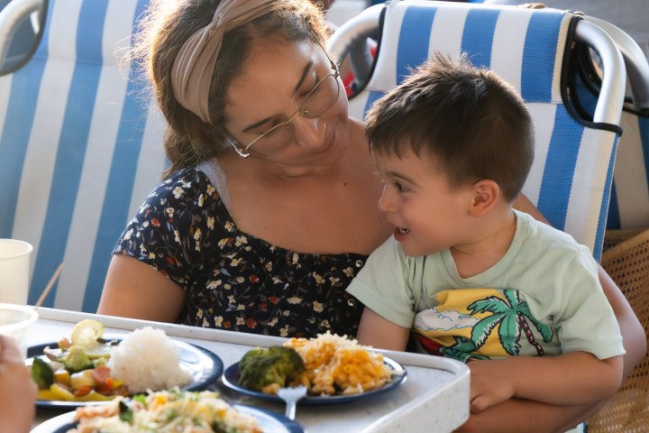 a person sitting at a table eating food