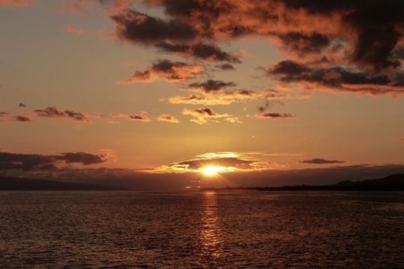 a sunset over a body of water