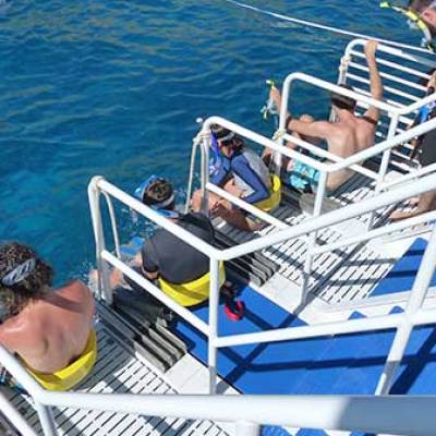 a group of people riding on the back of a boat